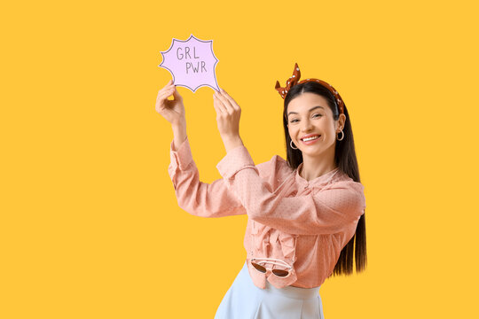 Young pin-up woman with GRL PWR sign on yellow background. Women's History Month
