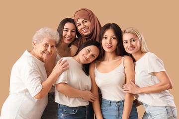 Obraz premium Group of beautiful women hugging on beige background. Women's History Month