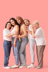 Fototapeta premium Group of beautiful women hugging on pink background. Women's History Month