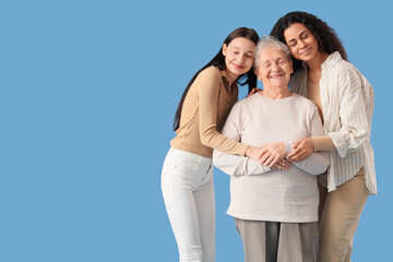 Beautiful women hugging on blue background. Women's History Month