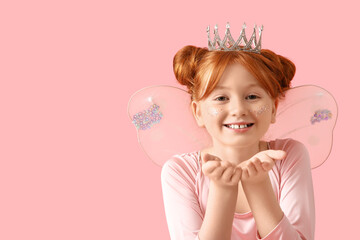 Cute girl in fairy costume blowing kiss on pink background