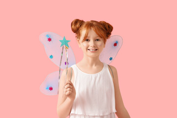 Cute girl in fairy costume with magic wand on pink background