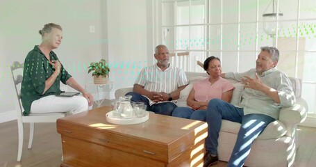 Host leaning forward and gesturing, leading health talk in living room with tablet, couple nodding - Powered by Adobe