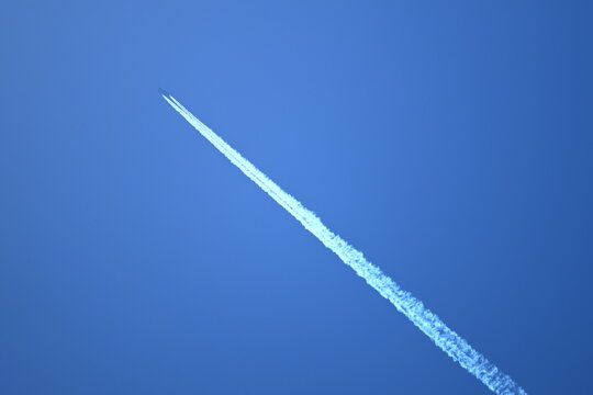 White contrails created by jet airplane flight - Powered by Adobe