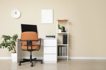 Interior of office with workplace, shelving unit and chair