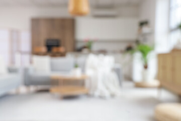 Blurred view of modern studio apartment with sofa and kitchen counters