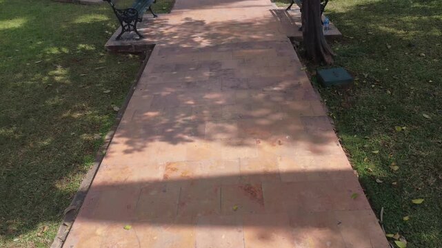 Ground-level view of the walkway and benches at Parque de La Ermita in M&eacute;rida, situated next to the historic church, reflecting local tradition, culture, and religious heritage.