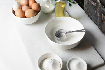  an empty white mixing bowl on a white countertop 
