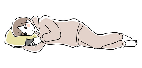 寝ながらスマホを見る女性1