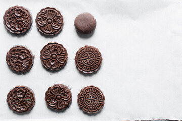 Overhead view of stamped chocolate cookies on a parchment lined tray
