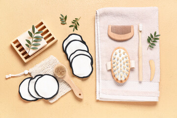 Reusable cotton pads with different bath supplies and massage tools on beige background