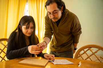 Close-Up of a Man Handing an Item to a Woman During a Home Craft Project