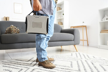 Fototapeta premium Young soldier with military laptop at home