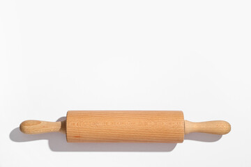 Wooden rolling pin on grey background