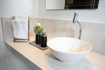 modern luxury bathroom sink detail, marble countertop with decor, white and black elegant interior, sophisticated washing area