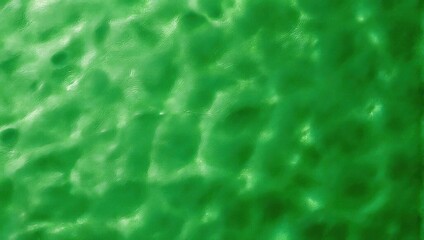 Abstract green water surface with light reflections and ripples.