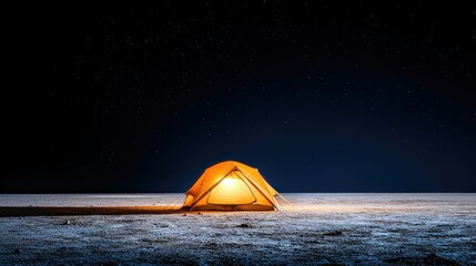 A brightly lit tent glows against a dark, starry night sky, creating a sense of peace and adventure.