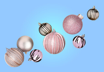 Christmas balls flying in air on light blue background
