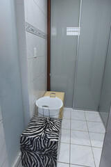 changing room interior with sliding closet doors, organization and storage space, functional dressing area, small dressing room with mirrored doors, zebra print stool and cleaning bucket, home service