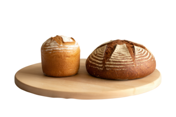 Two artisan sourdough loaves with golden crusts resting on a wooden board against a dark background