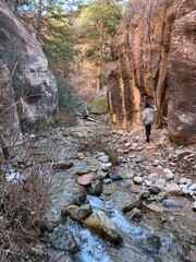 Kanarra Falls hiking trail. Kanarraville, Utah. Gorgeous canyoneering river hike. waterfalls and slot canyons. Next to Kolob Canyon, Zion national park. Ankle to knee deep water. Red rock mountains. 