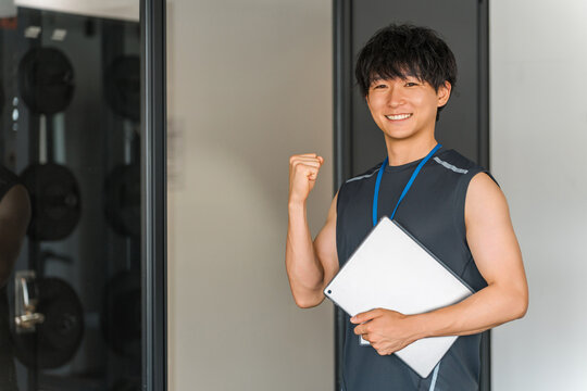 Male gym trainer, personal trainer, and instructor with tablet
