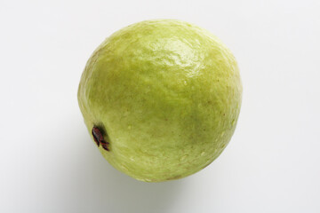 One whole green guava fruit, isolated on a white background.