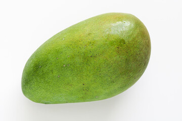 One whole Kiojay mango placed on a clean white background, showcasing their smooth green skin and elongated shape.