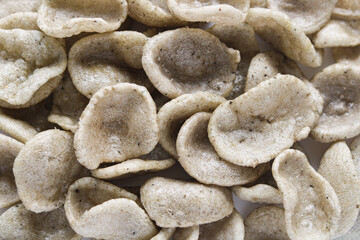 Closeup pile of kerupuk jengkol (jengkol crackers).