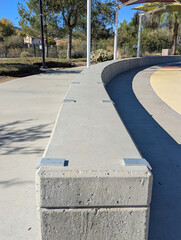 A view of several skateboard deterrents on a concrete bench