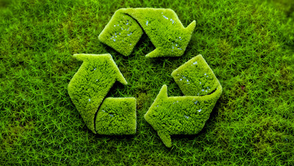 Green recycling symbol made of grass on lush lawn