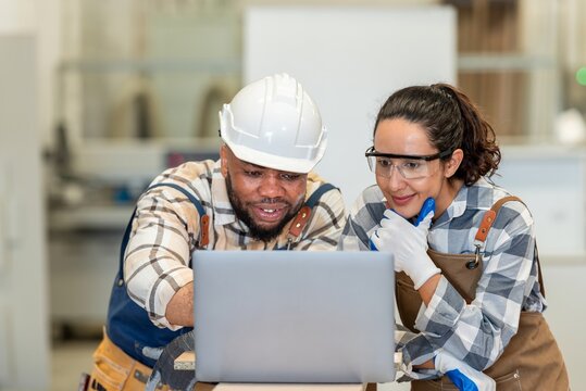 Two colleague young aged carpenter standing aim equipment tool for wood furniture at wood plank in workshop. coworker carpenter working craft with wood diy tool in workbench shop carpentry