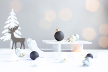 Minimalist Christmas Scene with Sled, Baubles and Reindeer Silhouette