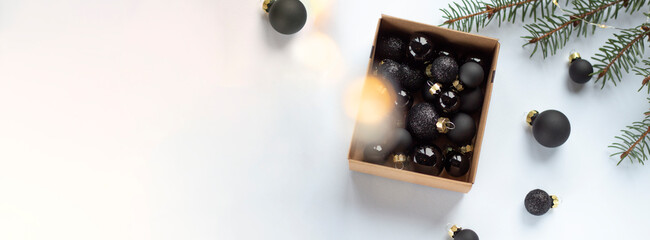 Minimalist Christmas Flatlay with Black Baubles and Gift Box
