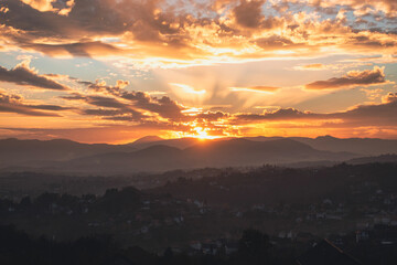 Dreamlike sunset over Bosnian hills outside Sarajevo, vivid tones and minimal horizon for modern design projects.