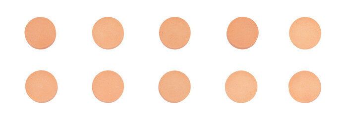 studio photograph of ten small, identical, round, peach-colored medicinal pills arranged in two neat, horizontal rows, isolated against a solid transparent background.