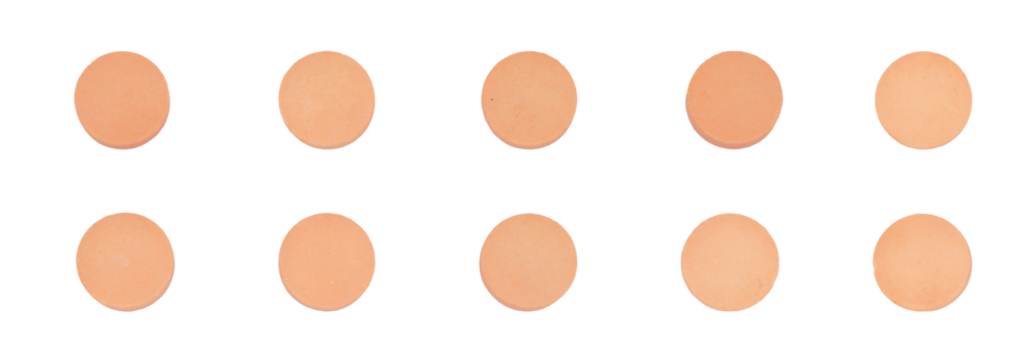 studio photograph of ten small, identical, round, peach-colored medicinal pills arranged in two neat, horizontal rows, isolated against a solid transparent background.