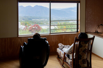 ホテルの宿泊部屋から景色を眺める女性