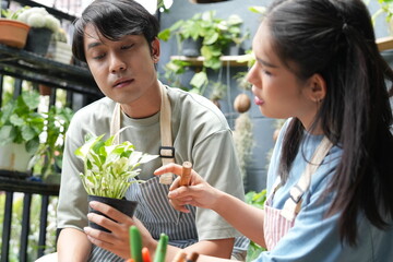 The couple takes care of the plants together, gardening in front of the house, fertilising and watering them