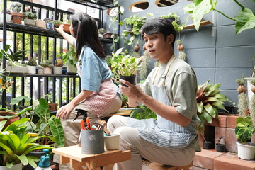 The couple takes care of the plants together, gardening in front of the house, fertilising and watering them