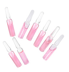 collection of seven glass medical or cosmetic ampoules filled with pink serum, arranged in a diagonal pattern on black.