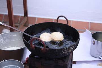 poori, puri deep fried in hot oil pot