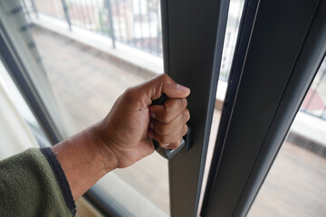 Hand reaching for sliding door handle