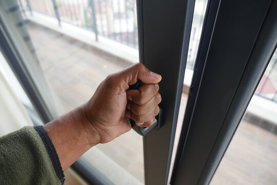 Hand reaching for sliding door handle