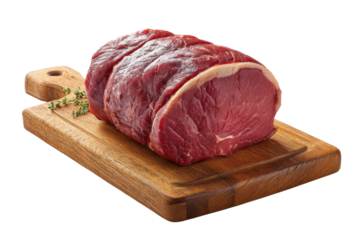 Raw beef roast with fat cap and thyme sprigs on wooden cutting board meat