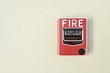 red fire alarm pull switch on wall for emergency safety with copy space