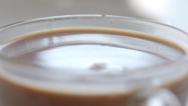 Mixing sugar into warm coffee for a perfect blend