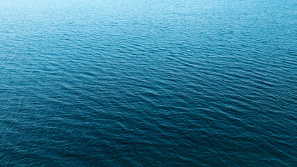 Top view of deep blue sea water surface with small ripples, aerial drone shot of turquoise ocean...