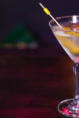 A sophisticated martini glass filled with a refreshing cocktail and adorned with olives