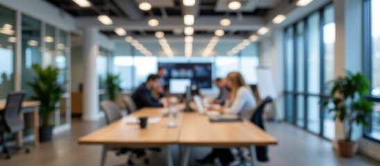Modern office workspace with professionals collaborating at a large table.